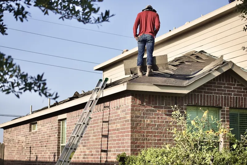 Professional roofer working on a residential roof in Middleville
